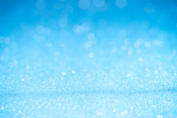 Blue glitter surface with blue light bokeh