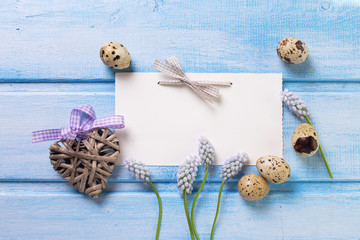  Decorative heart, eggs, spring flowers on  blue wooden backgrou