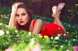 The girl's face. Beautiful girl with flowers. Red dress. Barefoot.