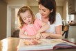 © Wavebreak Media - Mother and daughter reading book together