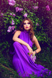 The girl's face. Beautiful girl with flowers. Lilac. Blue dress.