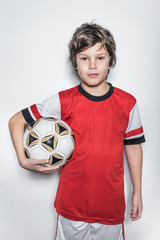 Soccer Player Boy in Red Uniform With Ball