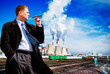 Businessman with cigar on industrial background