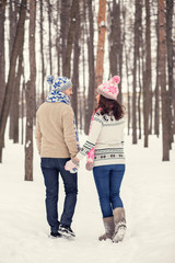 Wall Mural - Woman and man are having walk in winter snowy countryside.