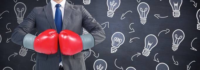 Poster - Composite image of businessman with boxing gloves