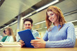 © Syda Productions - happy students with tablet pc in library