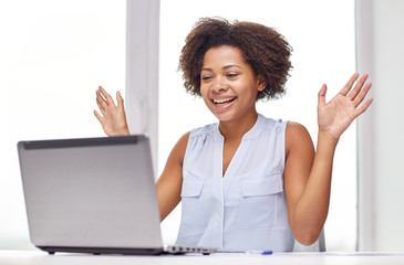 Wall Mural - happy african woman with laptop at office