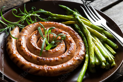 Nowoczesny obraz na płótnie Grilled sausage with asparagus and rosemary