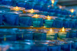 Dark artistic blue glass votive candles with selective focus 