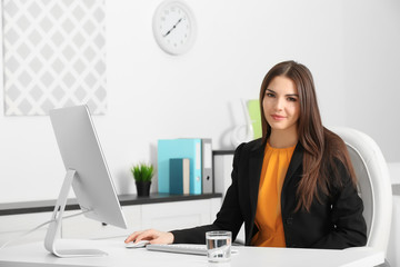 Wall Mural - A beautiful successful woman working at the modern office