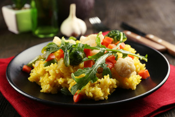 Sticker - Black plate with vegetable risotto on served wooden table