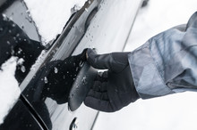 Closeup Of Man Hand Opening Frozen Car Door In Winter
