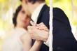 © monoliza - groom holds the bride's hand