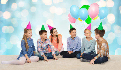 happy smiling children in party hats on birthday