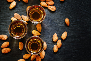 Amaretto almond liqueur with a dark background, top view