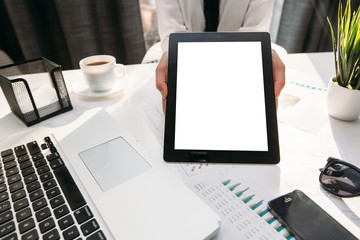 Wall Mural - business woman in her office presenting a tablet computer 