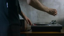 4K Cinemagraph - Motion Photo Seamless Loop - Young Adult Caucasian Male Playing Vinyl Record On A Vintage Record Player