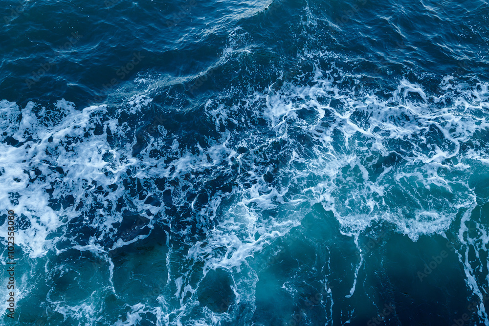 Blue sea texture with waves and foam - obrazy, fototapety, plakaty 