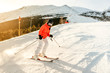 © aboutmomentsimages - Skier on the slope in the mountains. Girl skiing on a sunny day