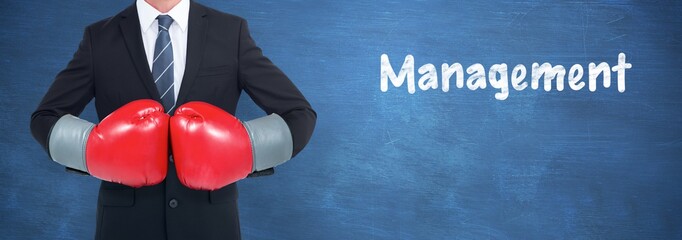 Poster - Composite image of businessman with boxing gloves