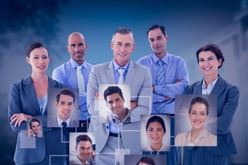 Composite image of business team working happily together