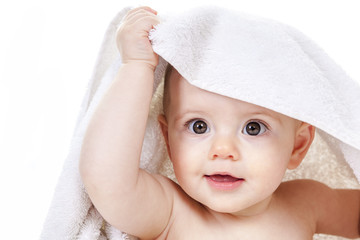 Sweet little boy sitting on studio white background