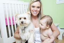 Mother And Baby With Dog In The Baby Room