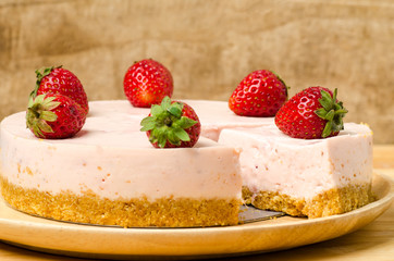 Homemade strawberry cheesecake  on white plate