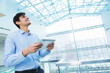 businessman leaning on balcony railings