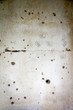 Wall in a house full of bulletholes and marks of the hands of children