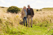 © micromonkey - Senior Couple Taking Dog For Walk In Countryside