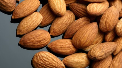 Wall Mural - Almonds over black background