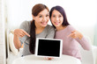 © leungchopan - Two woman showing tablet pc
