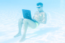 Young Man Enjoying His Laptop Underwater