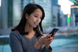 © leungchopan - Asian woman look at cellphone
