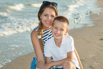 Mother and her son having fun on the beach