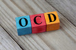 OCD (Obsessive Compulsive Disorder) text on colorful wooden cube