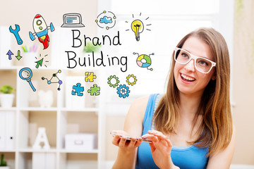 Wall Mural - Brand Building concept with young woman