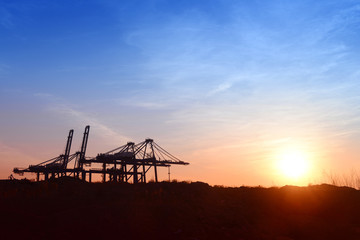 Wall Mural - Working cranes, in the evening