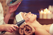 close up of young woman having face massage in spa