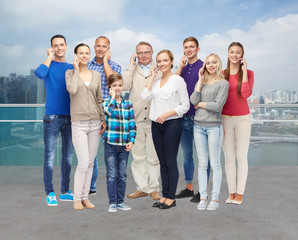 Wall Mural - group of smiling people with smartphones