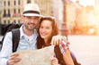 © Production Perig - Couple of young attractive tourists watching map