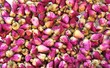 Dried pink rose buds in bulk background