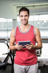 Wall Mural - Smiling man holding tablet