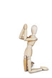 Praying man on the knees isolated over white. Abstract image with wooden puppet