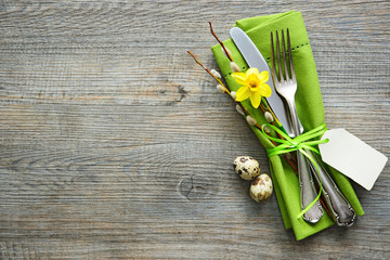 Easter table setting with daffodil and cutlery