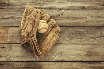 Wall Mural - Old baseball and mitt on rough wood background