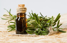 Fresh Rosemary And A Bottle Of Essential Oil