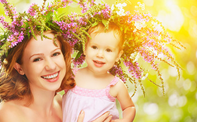 Wall Mural - happy laughing daughter hugging mother in wreaths of summer flow