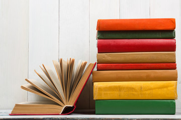 Open book, hardback books on wooden table. Back to school. Copy space